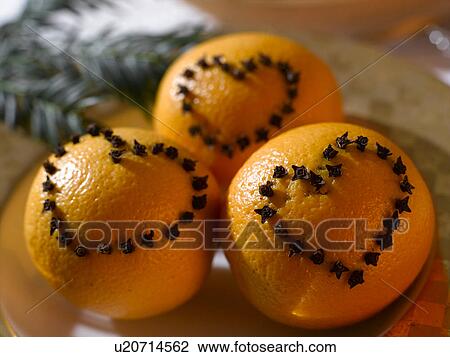 Stock Image - Oranges with a heart pattern made of cloves. Fotosearch