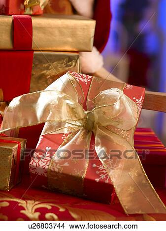 Red Christmas gift with a golden ribbon View Large Photo Image Picture - Red Christmas gift with a golden ribbon. Fotosearch