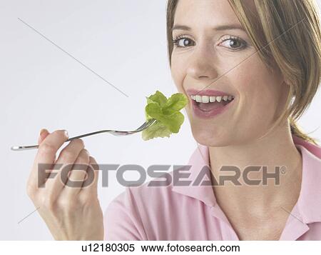 Woman is eating salad View Large Photo Image Stock Photography - Woman is eating salad. Fotosearch