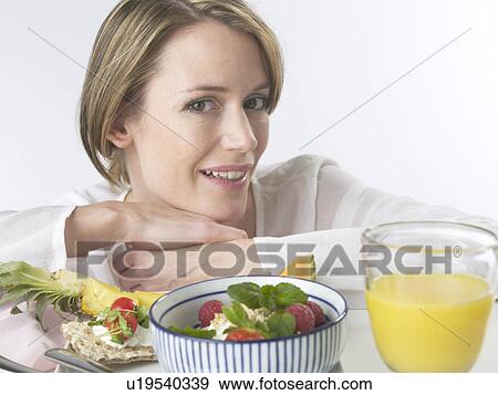 Woman is having breakfast with crispbread and cereals View Large Photo Image Stock Photo - Woman is having breakfast with crispbread and cereals. Fotosearch