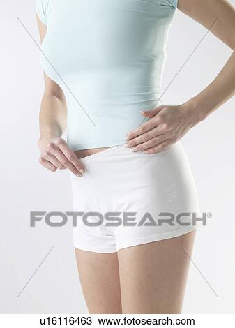 Stock Image - Woman wearing white shorts. Fotosearch