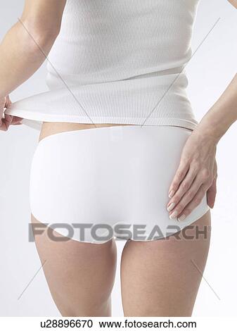 Woman wearing white underwear, cut of backside View Large Photo Image Stock Image - Woman wearing white underwear, cut of backside. Fotosearch