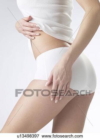 Woman wearing white underwear, cut of waist and backside View Large Photo Image Stock Photo - Woman wearing white underwear, cut of waist and backside. Fotosearch