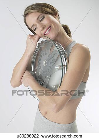 Woman with a bathroom scale View Large Photo Image Stock Image - Woman with a bathroom scale. Fotosearch