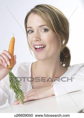 Stock Image - Woman with a carot. Fotosearch
