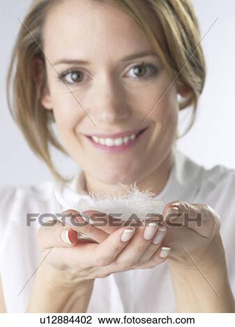 Woman with a feather View Large Photo Image Stock Image - Woman with a feather. Fotosearch
