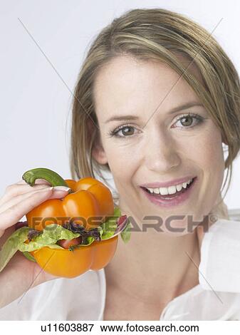 Stock Photo - Woman with a paprika pepper burger. Fotosearch