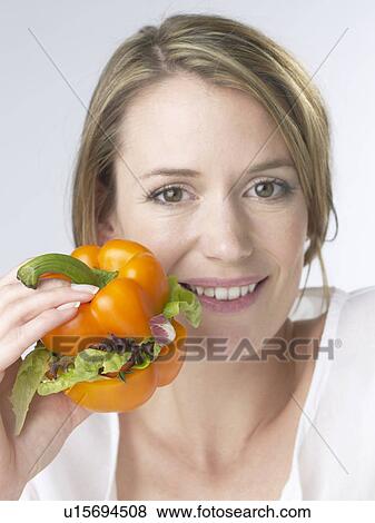 Stock Photo - Woman with a paprika pepper burger. Fotosearch
