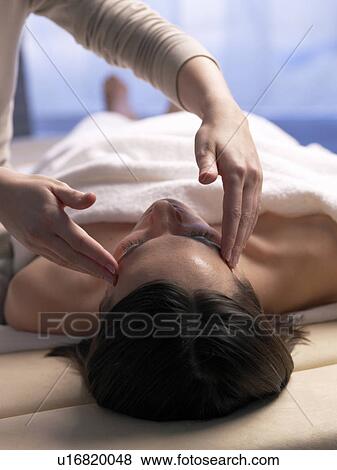 Stock Photo - Woman getting a facial massage. Fotosearch