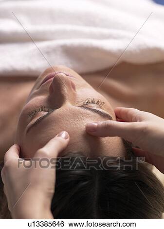 Woman getting a facial massage View Large Photo Image Stock Photograph - Woman getting a facial massage. Fotosearch