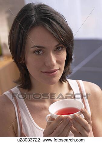 Stock Image - Woman with a cup of tea. Fotosearch
