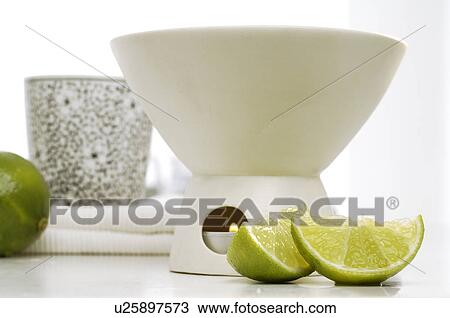 Stock Image - Aroma lamp with lime. Fotosearch