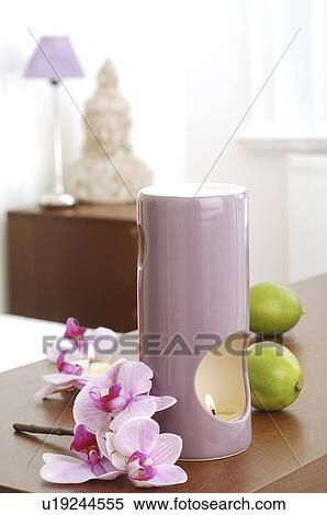 Aroma lamp with orchid blossoms and limes View Large Photo Image Stock Photography - Aroma lamp with orchid blossoms and limes. Fotosearch