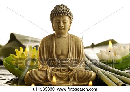 Stock Image - Buddha with smoke and candles looking like water lilies. Fotosearch