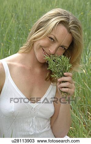 White dressed women with a bunch of weeds is sitting in a meadow View Large Photo Image Stock Image - White dressed women with a bunch of weeds is sitting in a meadow. Fotosearch