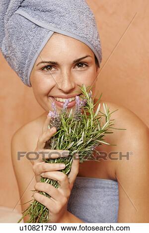 Woman in the bathroom with a bunch of lavender View Large Photo Image Stock Image - Woman in the bathroom with a bunch of lavender. Fotosearch