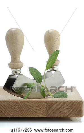 Stock Photograph - Cutting herbs with a mincing knife. Fotosearch