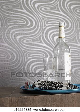 Bottle and glass on a tray View Large Photo Image Stock Photography - Bottle and glass on a tray. Fotosearch