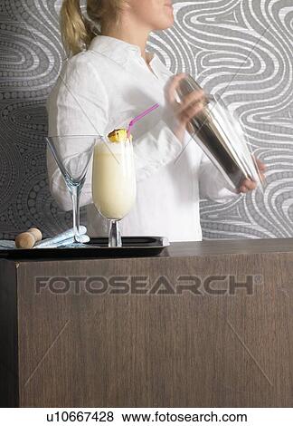 Cocktail bar and bar tender View Large Photo Image Stock Photo - Cocktail bar and bar tender. Fotosearch