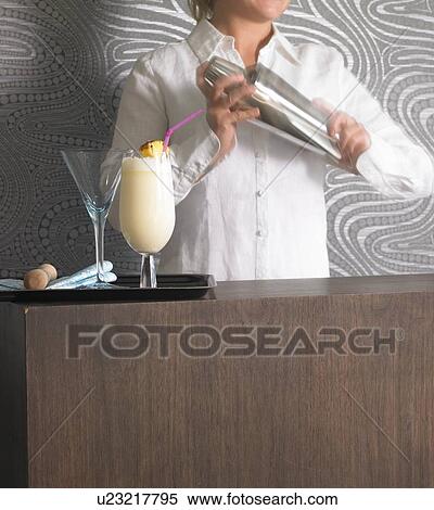 Stock Photography - Cocktail bar and bar tender. Fotosearch