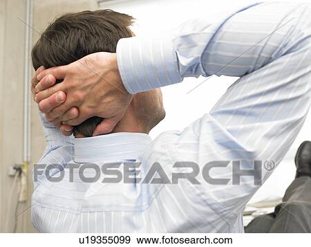 Business man is crossing his arms behind his head View Large Photo Image Stock Photo - Business man is crossing his arms behind his head. Fotosearch