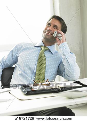 Stock Photo - Business man on his desk. Fotosearch