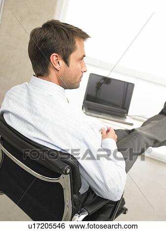 Business man with feet on desk View Large Photo Image Stock Photograph - Business man with feet on desk. Fotosearch