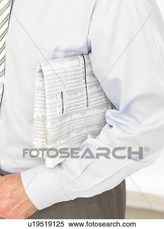 Stock Photography - Newspaper under the arms. Fotosearch