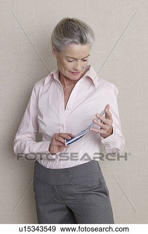 Senior adult with flight ticket View Large Photo Image Stock Photo - Senior adult with flight ticket. Fotosearch