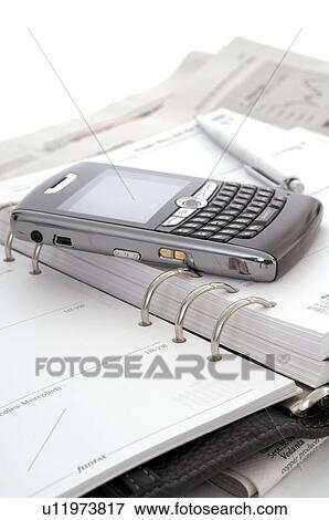 Stock Photo - Smartphone and a date book. Fotosearch