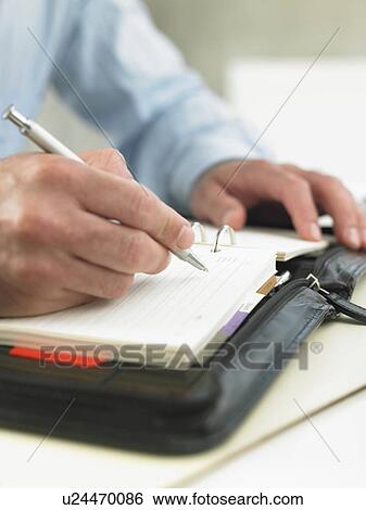 Stock Photograph - Writing in a datebook. Fotosearch