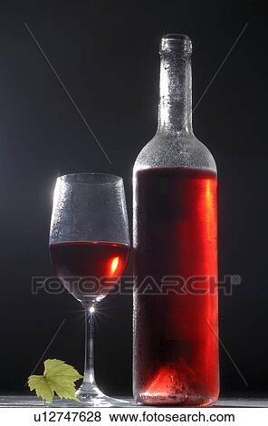 Stock Photo - Bottle and glass of red wine. Fotosearch