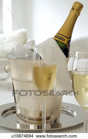 Champagne bottle in an ice bucket and two champagne glasses View Large Photo Image Picture - Champagne bottle in an ice bucket and two champagne glasses. Fotosearch