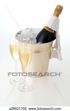 Champagne bottle in an ice bucket and two champagne glasses View Large Photo Image Stock Image - Champagne bottle in an ice bucket and two champagne glasses. Fotosearch