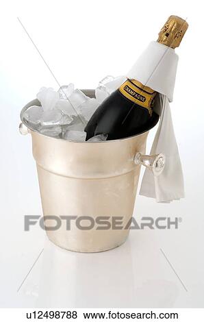 Champagne bottle in an ice bucket View Large Photo Image Stock Photo - Champagne bottle in an ice bucket. Fotosearch