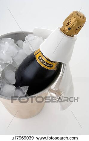 Stock Photo - Champagne bottle in an ice bucket. Fotosearch