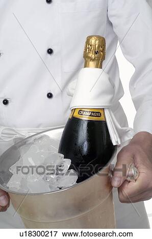 Stock Photo - Champagne bottle in an ice bucket. Fotosearch