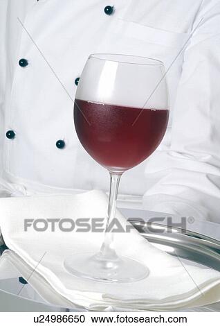 Glas of red wine on a tray View Large Photo Image Stock Image - Glas of red wine on a tray. Fotosearch