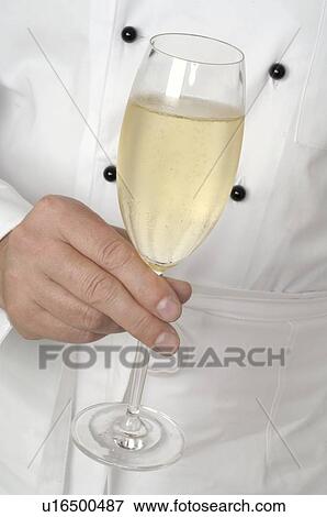 Stock Photo - Holding a champagne glass. Fotosearch