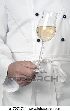 Holding a glass of white wine View Large Photo Image Picture - Holding a glass of white wine. Fotosearch