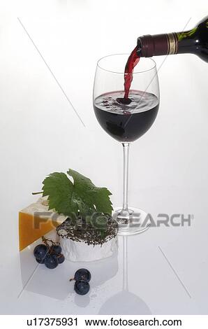 Stock Image - Pouring wine into a wine glass. Fotosearch