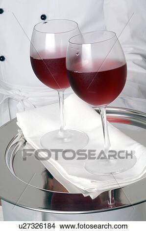 Picture - Two glasses of red wine on a tray. Fotosearch