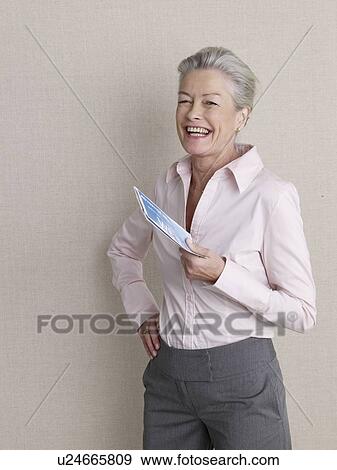 Senior adult holding air ticket View Large Photo Image Stock Photo - Senior adult holding air ticket. Fotosearch