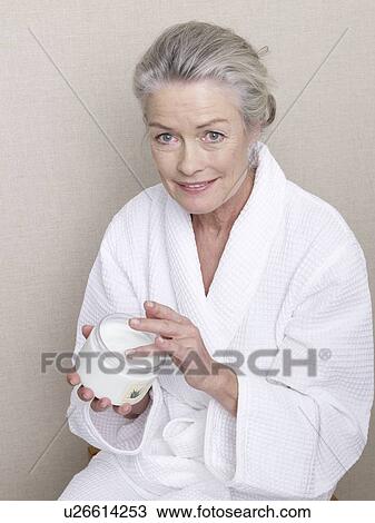 Senior adult in bathrobe body cream View Large Photo Image Stock Image - Senior adult in bathrobe body cream. Fotosearch