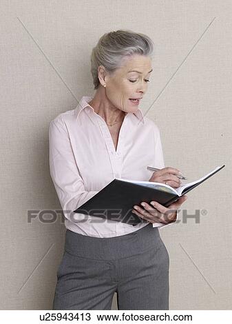 Senior adult in business clothing holding datebook View Large Photo Image Stock Image - Senior adult in business clothing holding datebook. Fotosearch