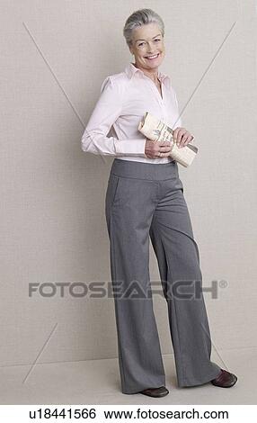 Stock Photograph - Senior adult in business clothing holding newspaper. Fotosearch