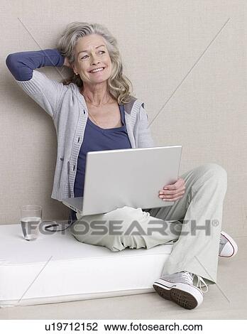 Senior adult in sports clothing with laptop View Large Photo Image Stock Image - Senior adult in sports clothing with laptop. Fotosearch