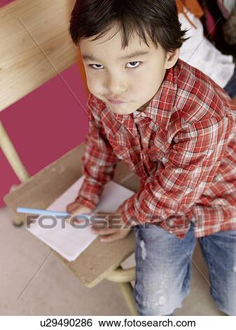 Asian boy with paper and pen View Large Photo Image Stock Photograph - Asian boy with paper and pen. Fotosearch