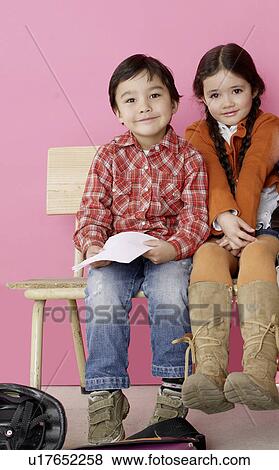 Stock Photo - Boy and girl sitting on a bench. Fotosearch
