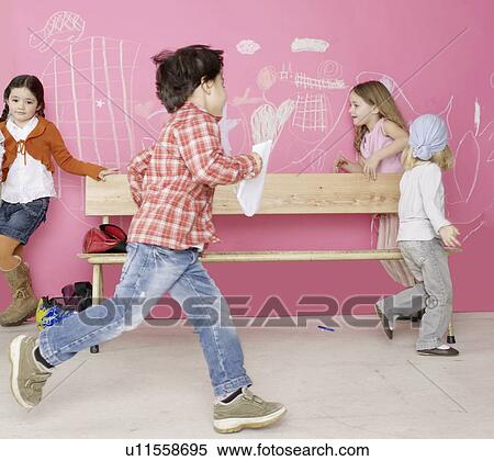 Stock Photography - Children running around a bench. Fotosearch